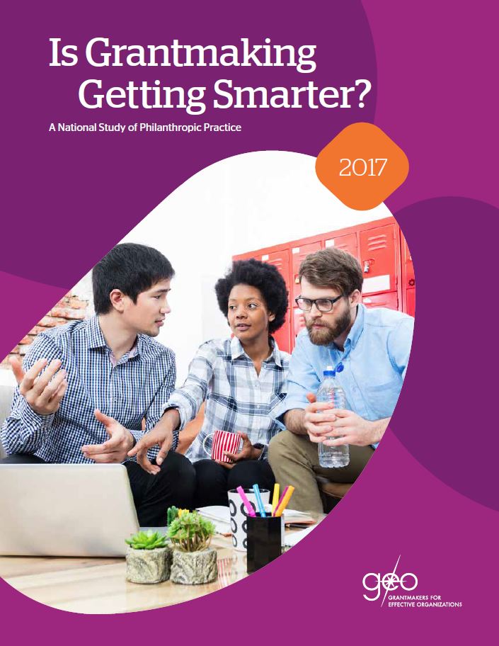 This cover has purple shapes that look like beans. In the middle is a picture of three business professionals looking at a computer and talking to one another.