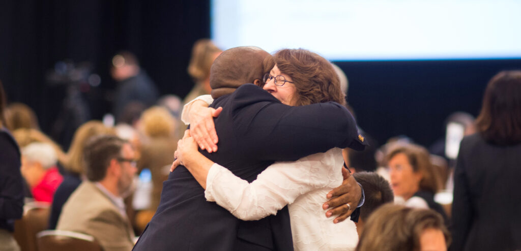 Photo of two people hugging each other.