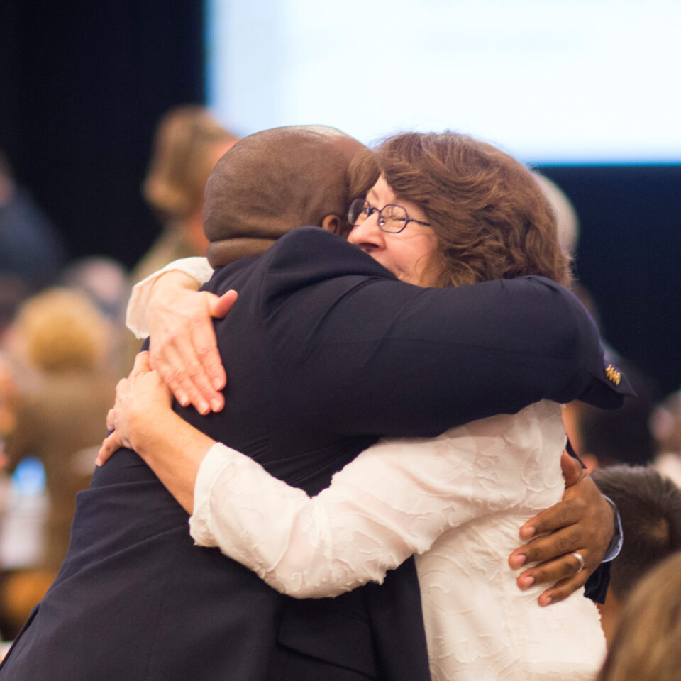 Photo of two people hugging each other.